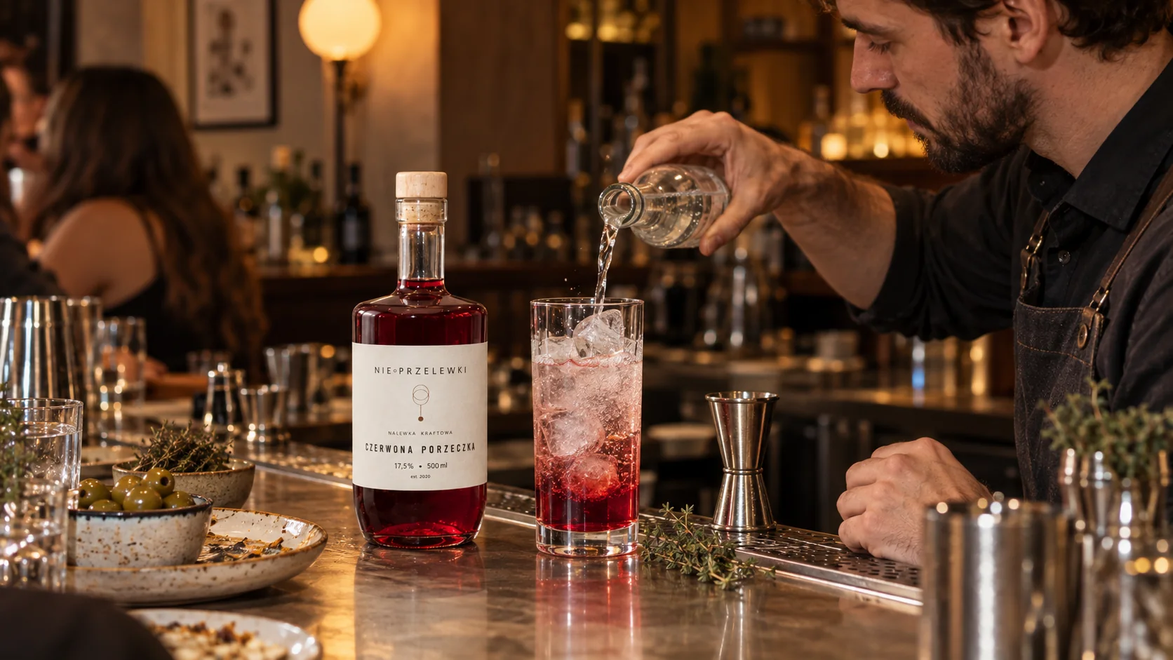 A bartender making a nalewka and tonic drink at a bar - nalewka cocktails