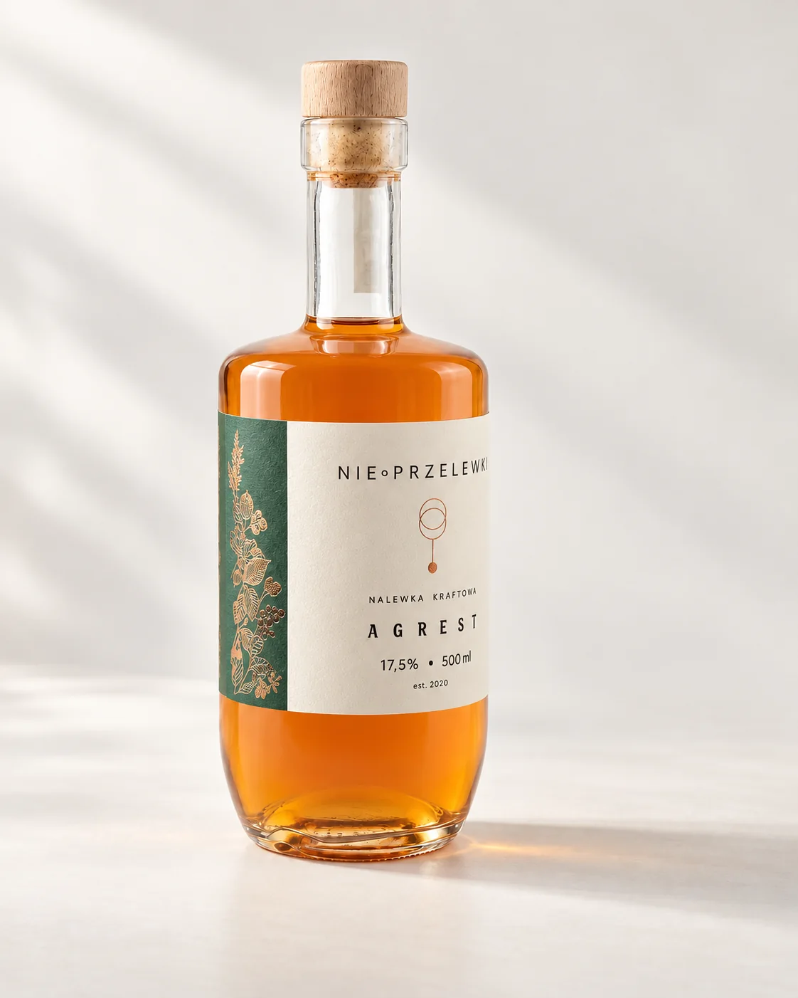 A 500 ml bottle of Gooseberry from the side, the colour of the liquid against the light
