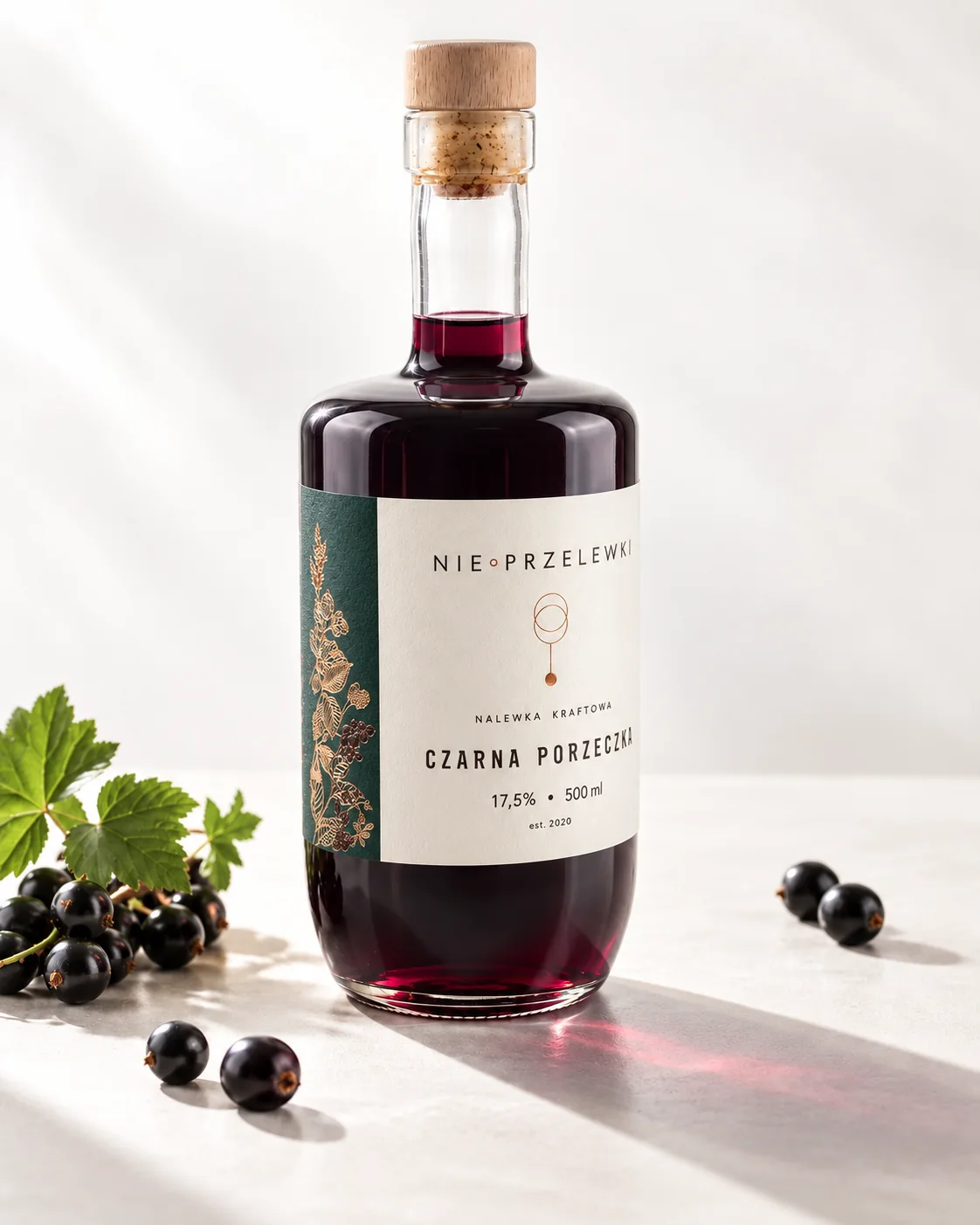 A 500 ml bottle of Blackcurrant from the side, the colour of the liquid against the light