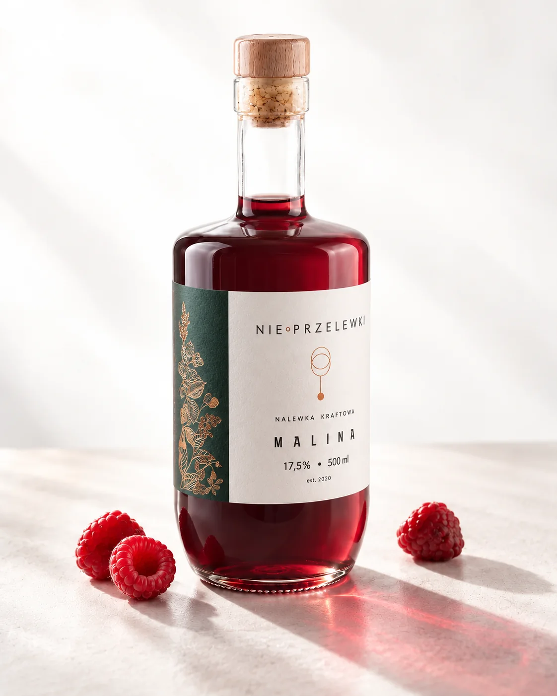 A 500 ml bottle of Raspberry from the side, the colour of the liquid against the light