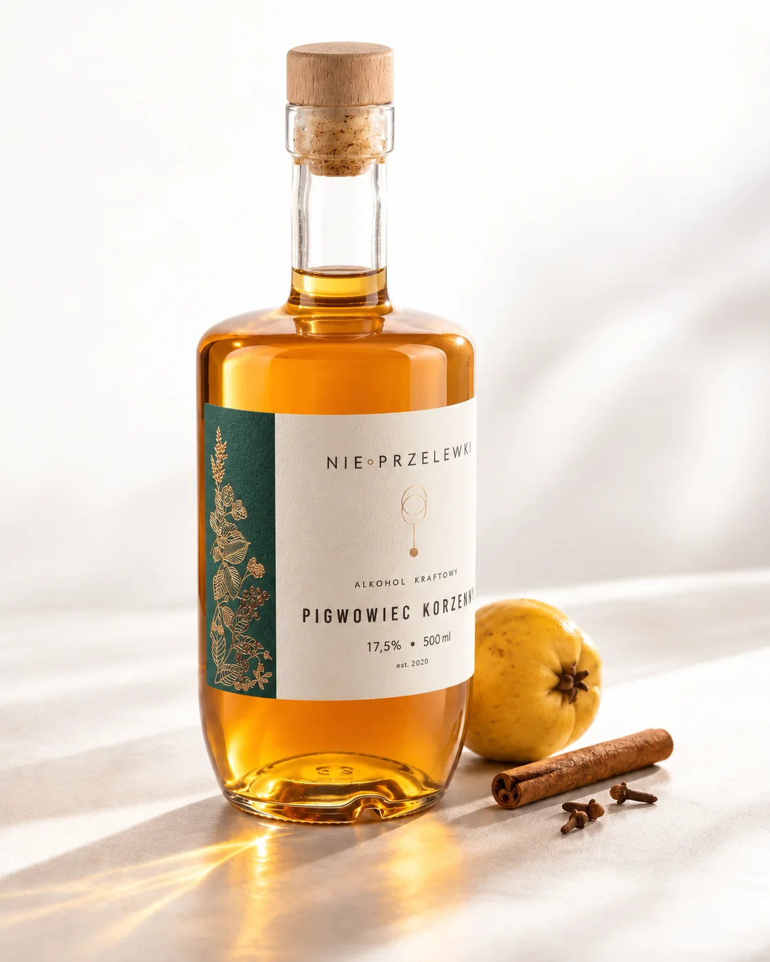 A 500 ml bottle of Spiced Quince from the side, the colour of the liquid against the light