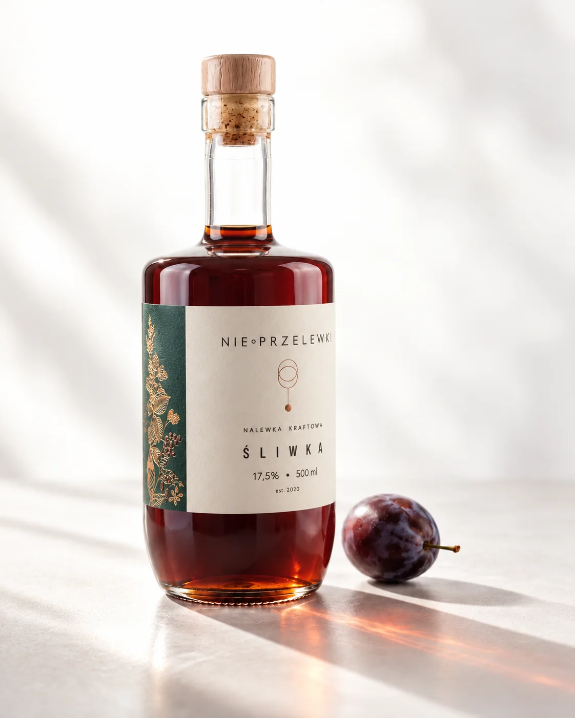 A 500 ml bottle of Plum from the side, the colour of the liquid against the light