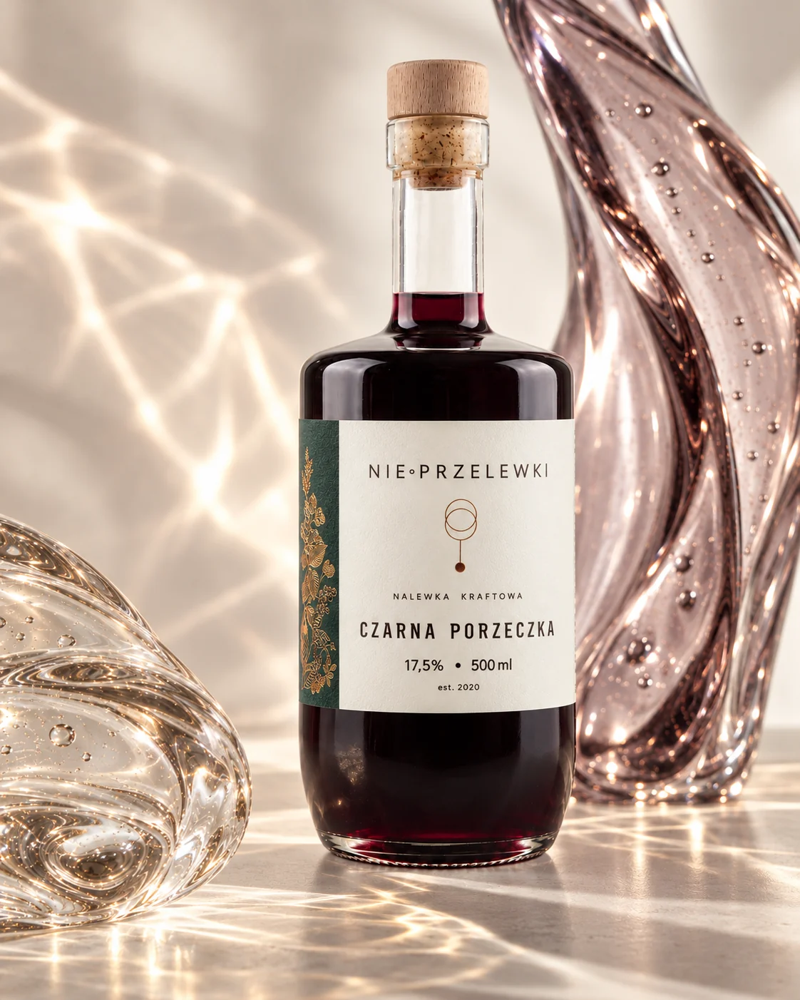 Nie Przelewki Blackcurrant nalewka 500 ml bottle among glass forms, light refracted in the glass