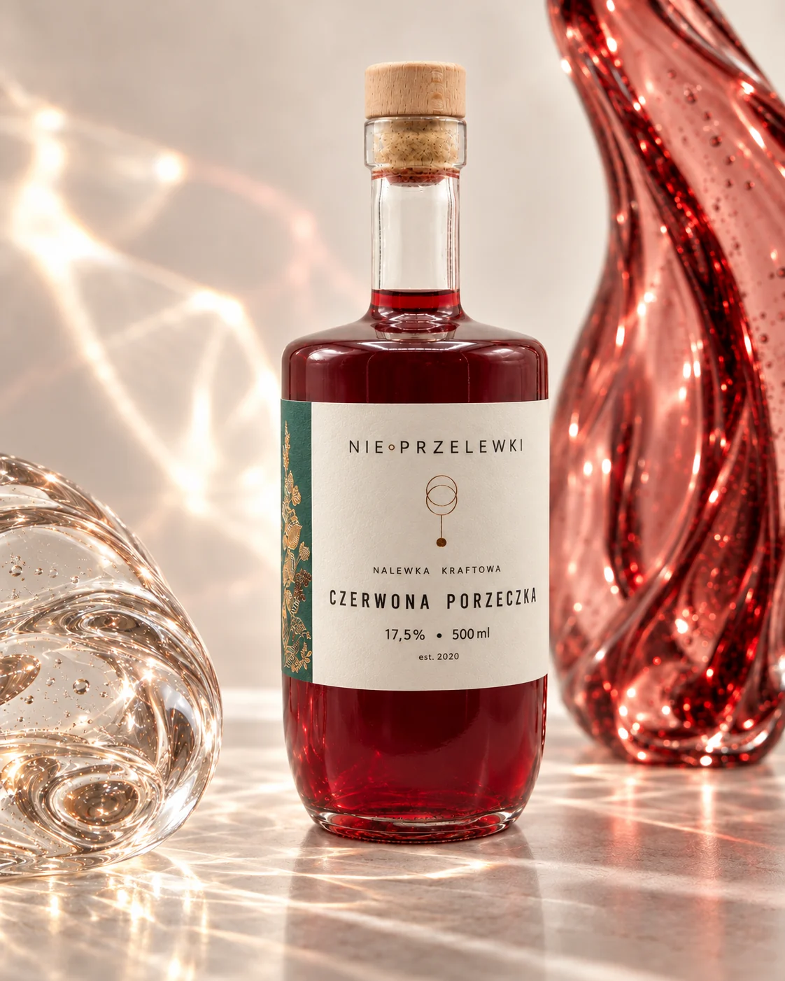Nie Przelewki Redcurrant nalewka 500 ml bottle among glass forms, light refracted in the glass
