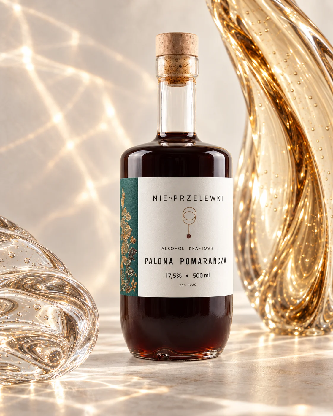 Nie Przelewki Burnt Orange 500 ml bottle, fruit-infused spirit, among glass forms, light refracted in the glass