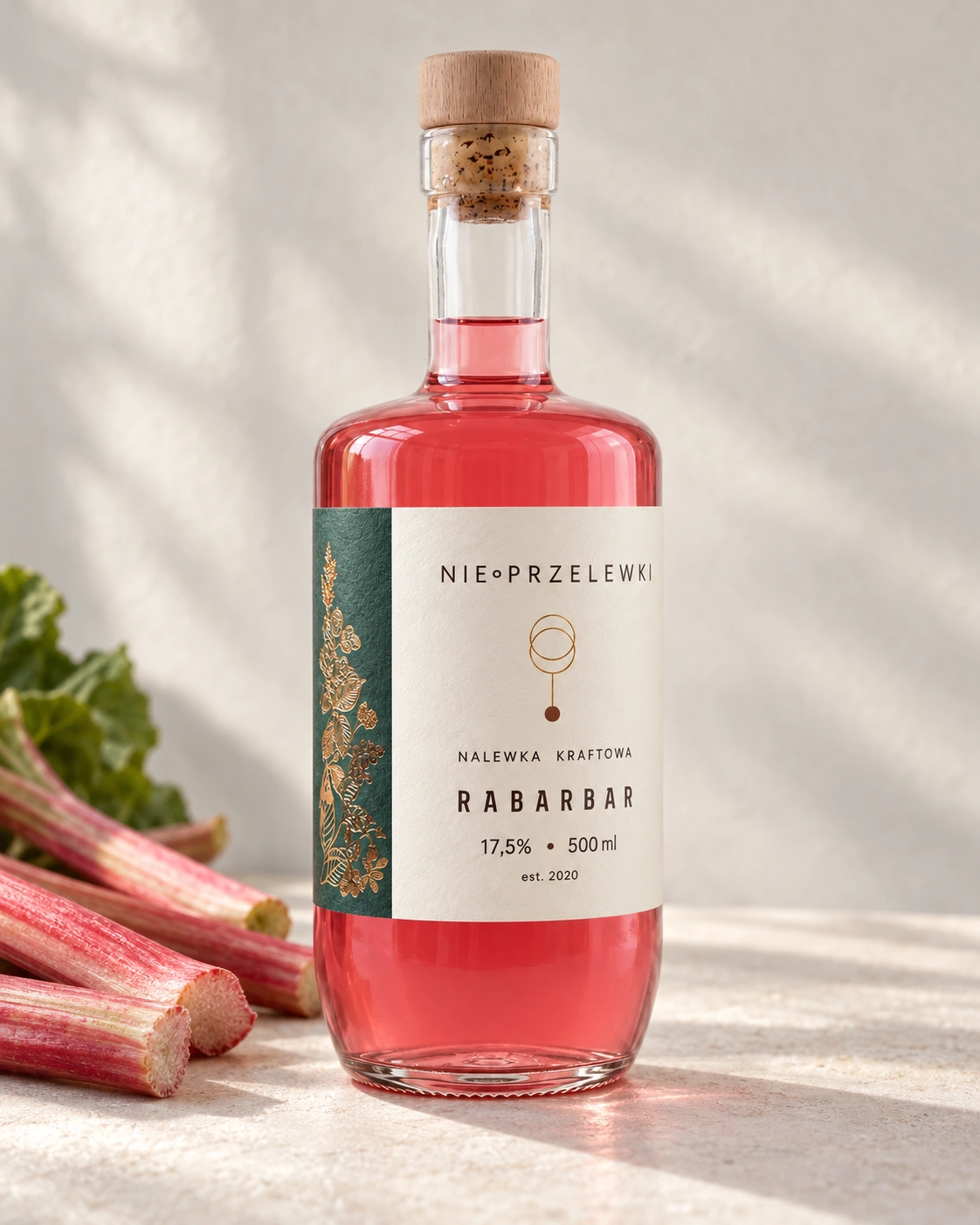 A 500 ml bottle of Rhubarb from the side, the colour of the liquid against the light